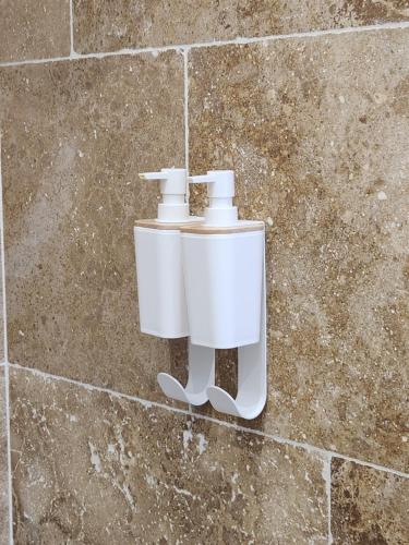 a white toilet hanging on a brick wall at Maison "COSY" avec Parking Privé et Climatisation in Nîmes