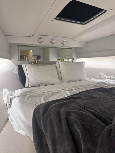 a bedroom with a large bed with a tv on the ceiling at Boat in Puerto de Mogán in Puerto de Mogán
