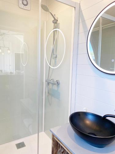 a bathroom with a sink and a shower at POD St Ives - LUXURY GLAMPING ACCOMMODATION in St Ives