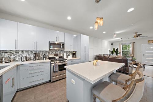 a kitchen with white cabinets and a table and chairs at Downtown Private Oasis Stay Fire Pit & Hot Tub in Houston