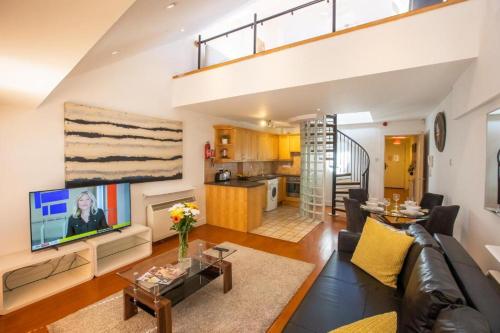 a living room with a couch and a tv at Grafton Street District Apartments in Dublin