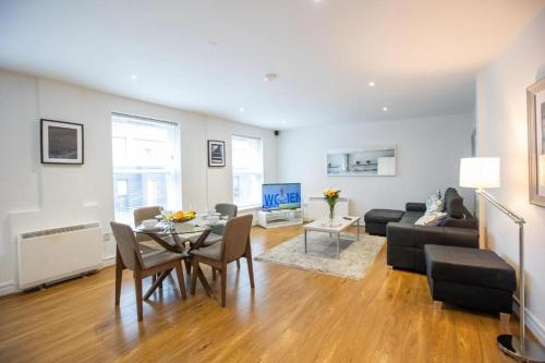 a living room with a table and a couch at Grafton Street District Apartments in Dublin