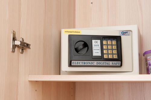 a electronic digital meter on top of a shelf at KC Kamala Guesthouse in Kamala Beach