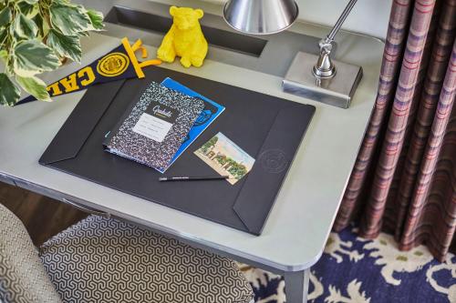 a table with a book on top of a table at Graduate by Hilton Berkeley in Berkeley