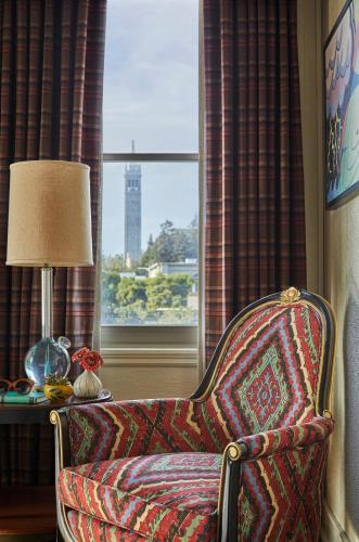 a living room with a chair and a lamp and a window at Graduate by Hilton Berkeley in Berkeley