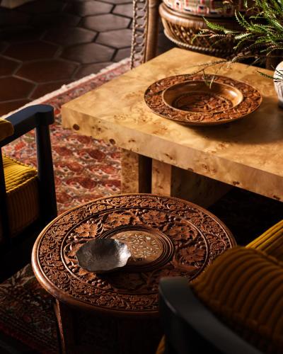 a wooden table with two plates on a wooden table at Graduate by Hilton Berkeley in Berkeley