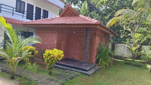 a small building in the yard of a house at Rithu Beach Villa in Alleppey