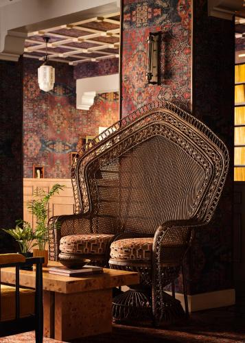 a wicker bench sitting in a room with a table at Graduate by Hilton Berkeley in Berkeley