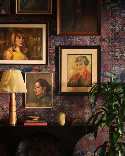 a room with portraits of people on a wall at Graduate by Hilton Berkeley in Berkeley