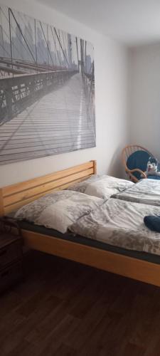 a bedroom with two beds and a picture of a pier at u Míši v Brdech in Příbram