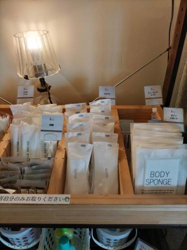 a shelf filled with lots of white bags of food at ターミナホテル東予 in Nyūgawa