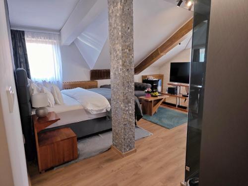 a bedroom with a bed and a pole at Green Land Club in Novi Banovci