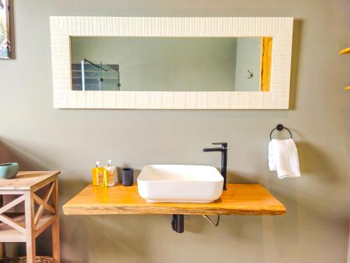 a bathroom with a sink and a mirror at Highland Peace Haven In Dullstroom in Dullstroom