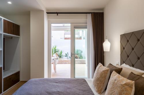 a bedroom with a bed and a sliding glass door at B&B Rais Luxury Rooms in Vieste