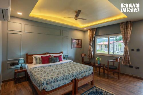 a bedroom with a bed and a ceiling fan at StayVista at Wildwoods Stone with Pool, Bathtub, Wi-Fi in Sawāi Mādhopur