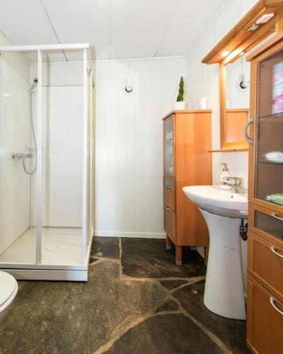 a bathroom with a shower and a sink at Nice House by the Sea with private beach and jetty in Hjelmeland
