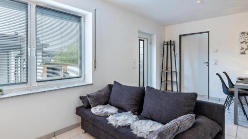 a living room with a couch and a window at Ferienwohnung am Donauradweg in Tuttlingen