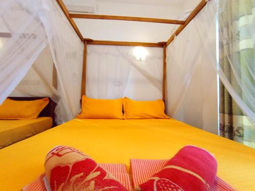 Postel nebo postele na pokoji v ubytování Pearl Deluna Resort Mirissa