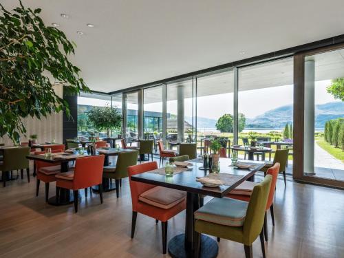 a restaurant with tables and chairs and large windows at The Europe Hotel & Resort in Killarney