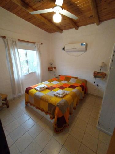 a bedroom with a bed in a room with a ceiling at Sol y Paz Valle Grande San Rafael in San Rafael