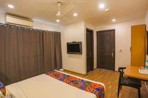 a hotel room with a bed and a tv and a room at FabHotel Moro Paschim Vihar in New Delhi