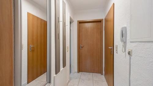 a hallway with wooden doors and a hallway sidx sidx sidx at Ferienwohnung Heidegarten in Radolfzell am Bodensee