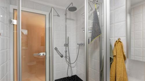 a shower with a glass door in a bathroom at Ferienwohnung Heidegarten in Radolfzell am Bodensee
