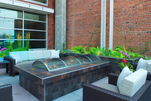a brick patio with a fire pit in front of a building at Courtyard by Marriott Seattle Everett Downtown in Everett
