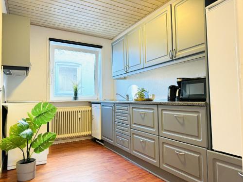 a kitchen with white cabinets and a window at aday - Hjorring 2 bedroom Bright Apartment in Hjørring