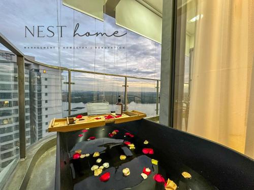 a room with a table with flowers on the floor at Country Garden Seaview Suite by Nest Home at Danga Bay in Johor Bahru