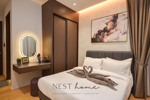 a bedroom with a bed with a swan on it at Country Garden Seaview Suite by Nest Home at Danga Bay in Johor Bahru