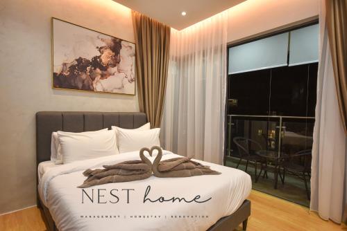 a bedroom with a bed with a nest home sign on it at Country Garden Seaview Suite by Nest Home at Danga Bay in Johor Bahru