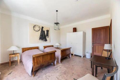 a bedroom with two beds and a desk and a refrigerator at Luxus Villa mit großem Pool Alleinlage Nähe Graz in Erbersdorf