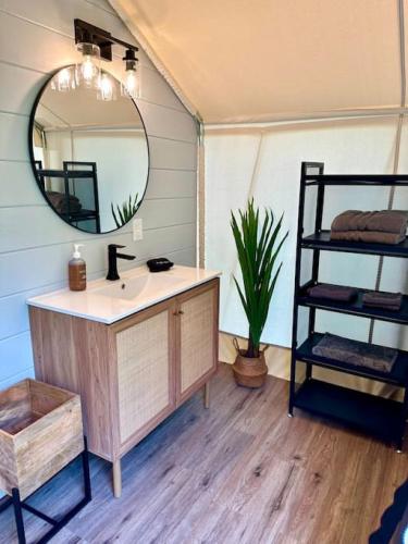 a bathroom with a sink and a mirror at Entire Glamping Campground, 8 Luxury Safari Tents in Cadiz