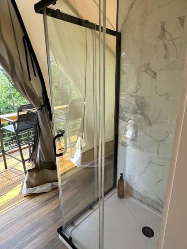 a shower with a glass door in a room at Entire Glamping Campground, 8 Luxury Safari Tents in Cadiz