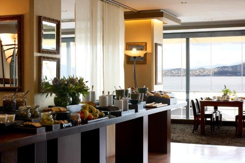a buffet in a room with a table with food at Domotel Xenia Volos in Volos