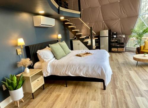 a bedroom with a large bed and a staircase at The Prince Dome at Nine Pines in Cadiz