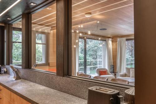 a large mirror in a room with a living room at Appartement Oberland in Megève