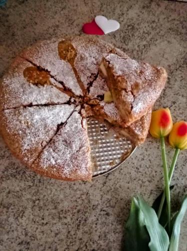 a piece of cake sitting on a plate with two slices at Chalet du soleil in Odecla
