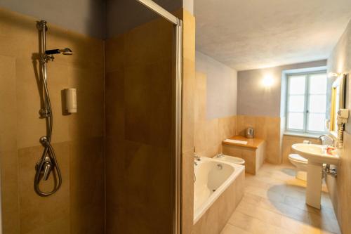 a bathroom with a shower and a toilet and a sink at Foresteria del Castello di San Giorgio Canavese in San Giorgio Canavese