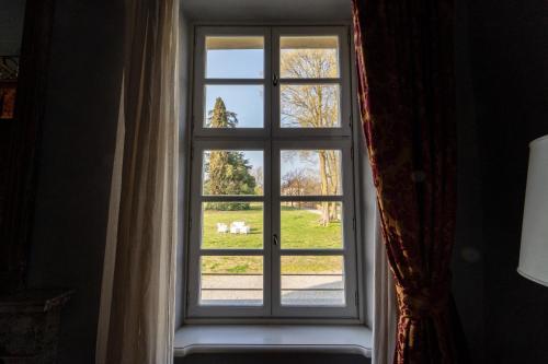 a window with a view of a yard at Foresteria del Castello di San Giorgio Canavese in San Giorgio Canavese
