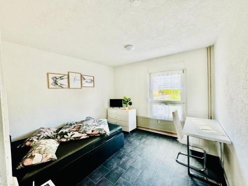 a bedroom with a bed and a desk in it at Ferienwohnung Heringen in Heringen