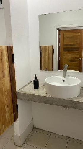 a bathroom with a white sink and a mirror at Think Koh Tao in Koh Tao