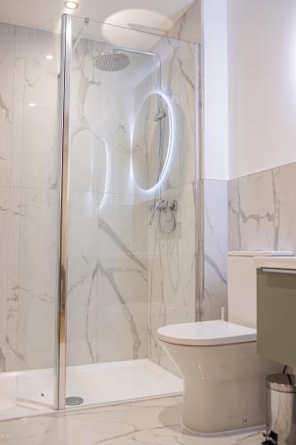 a bathroom with a shower and a toilet at Charles Hope Salisbury Centre in Salisbury