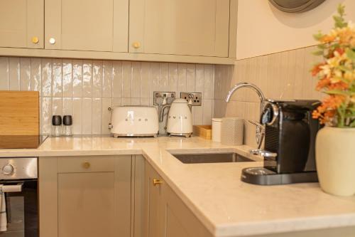 a kitchen counter top with a sink and appliances at Charles Hope Salisbury Centre in Salisbury