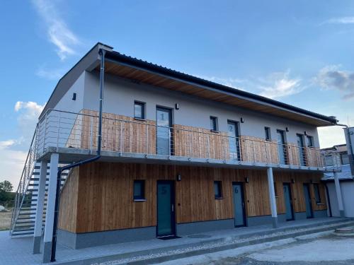 a building with a balcony on the side of it at JK Apartmány in Bělkovice