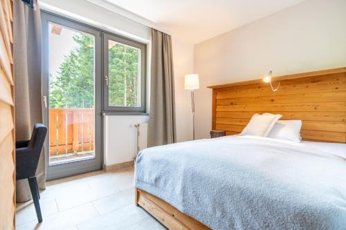 Postel nebo postele na pokoji v ubytování Heimat - Das Natur Resort