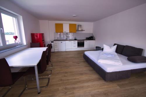 a room with a couch and a table and a kitchen at Gemütliche Wohnung im schönen Chiemgau in Traunreut