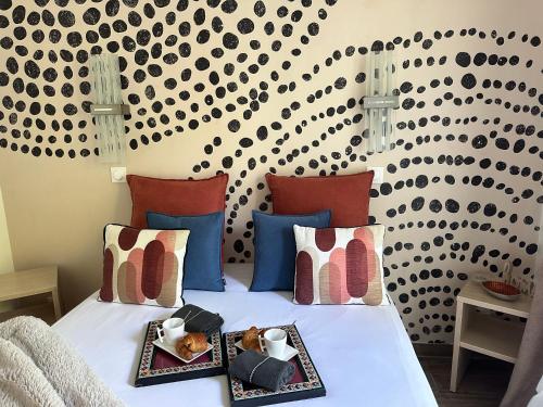 a bedroom with a bed with two plates of food on it at Immodēly & la Magie de Disney in Serris