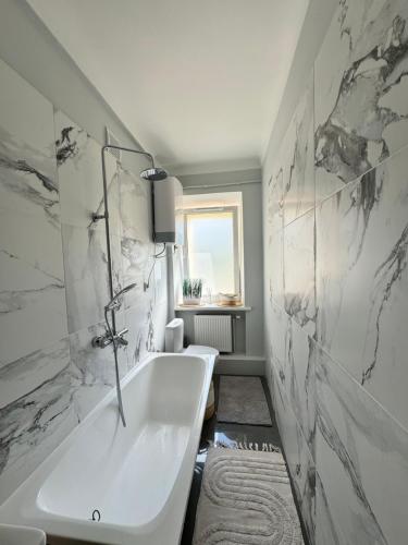 a bathroom with a tub and a sink at EVIS LTD apartments 3 in Rēzekne